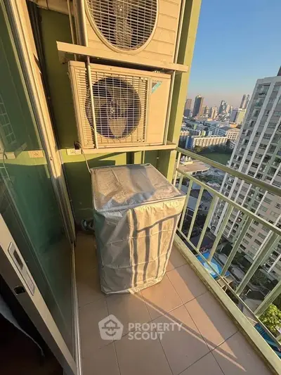 High-rise balcony with city view and air conditioning units, perfect for urban living.
