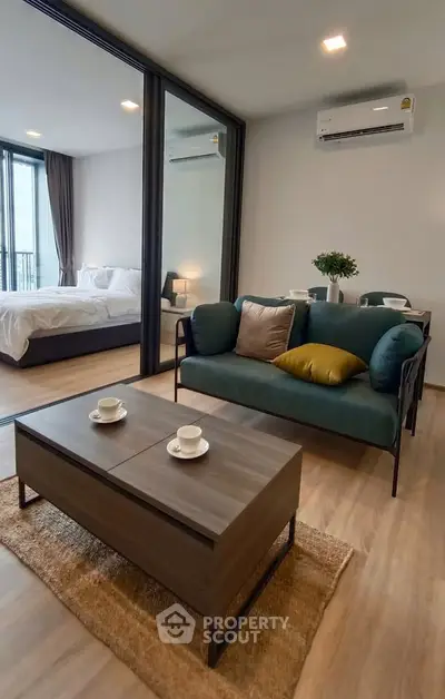 Modern living room with stylish furniture and view into a cozy bedroom, perfect for urban living.