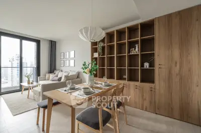 Modern living room with dining area, large windows, and stylish wooden shelving.