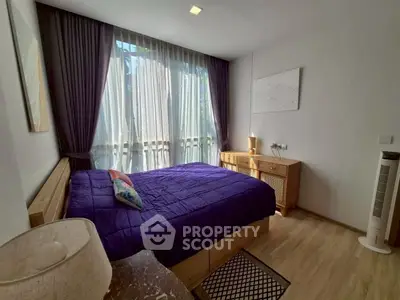 Cozy bedroom with natural light and stylish wooden furniture