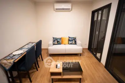 Modern living room with cozy sofa, stylish table, and air conditioning in a contemporary apartment.