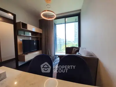 Modern living room with stylish furniture and large window offering a scenic view.