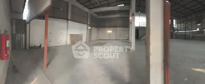 Spacious industrial warehouse with high ceilings and ample storage space.