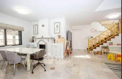 Spacious living room with elegant staircase and modern decor