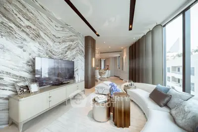 Luxurious modern living room with elegant decor and large windows offering natural light.