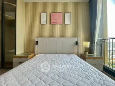 Modern bedroom with stylish decor and large window offering city view