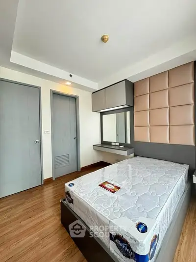 Modern bedroom with stylish wall paneling and wooden flooring