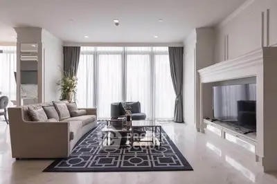 Luxurious living room with elegant decor and large windows offering natural light.