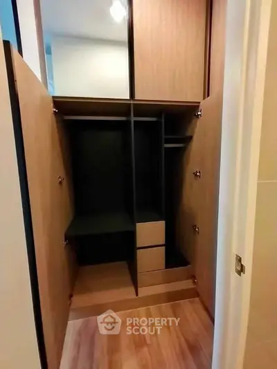 Spacious walk-in closet with wooden finish and ample storage space.