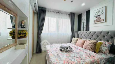 Charming bedroom with stylish decor and natural light, perfect for relaxation and comfort.