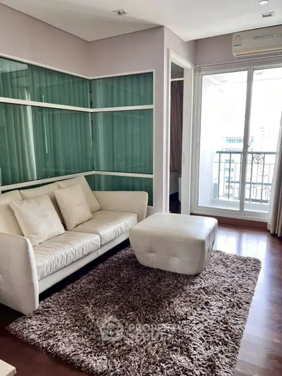 Modern living room with cozy sofa and balcony access in stylish apartment