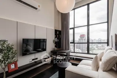Modern living room with large windows and city view, featuring sleek furniture and stylish decor.