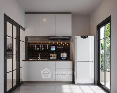 Modern kitchen with sleek cabinetry and large windows for natural light.