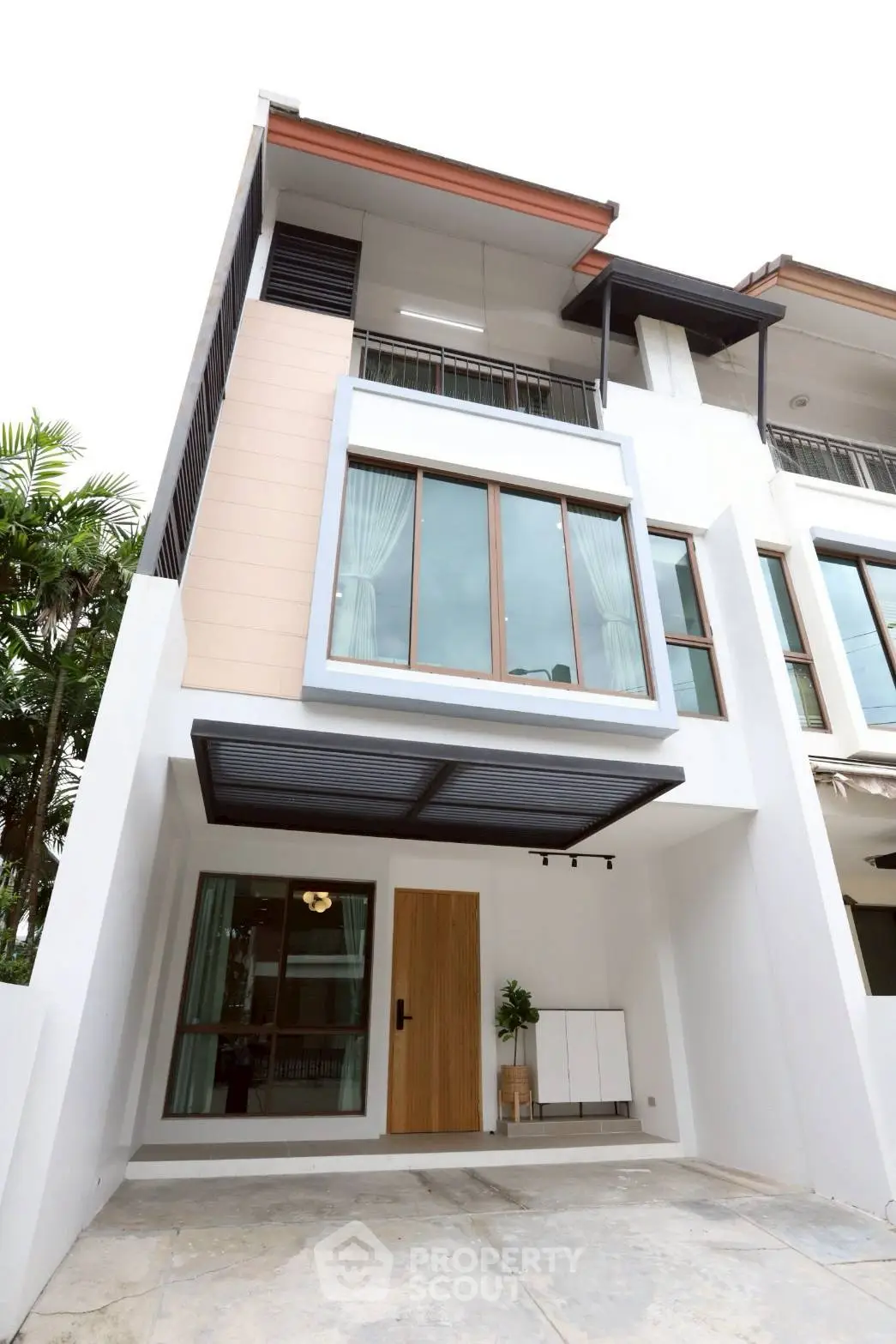 Modern townhouse exterior with large windows and stylish entrance