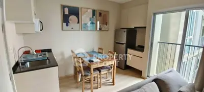 Modern kitchen with dining area and balcony access in a stylish apartment.