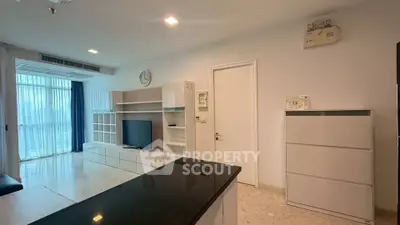 Modern living room with sleek furniture and large windows offering natural light.