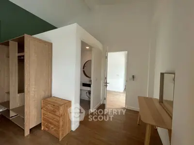 Spacious bedroom with modern wooden furniture and ensuite bathroom, perfect for comfortable living.