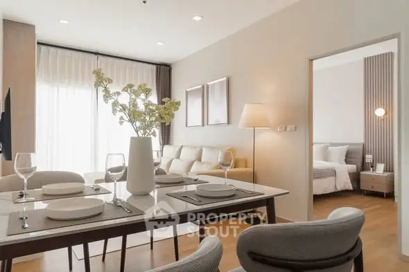 Modern open-plan living and dining area with elegant decor and natural light.