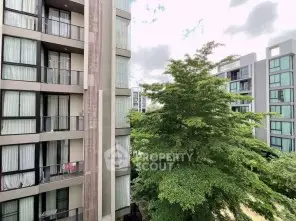 Modern apartment buildings with lush greenery and large windows