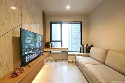 Modern living room with sleek design and large TV, perfect for relaxation.