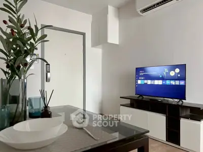 Modern living room with sleek furniture and wall-mounted TV, perfect for cozy evenings.
