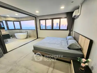 Luxurious bedroom with panoramic city view and modern bathtub