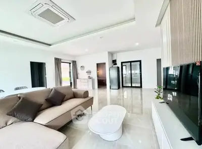 Spacious modern living room with sleek design and neutral tones