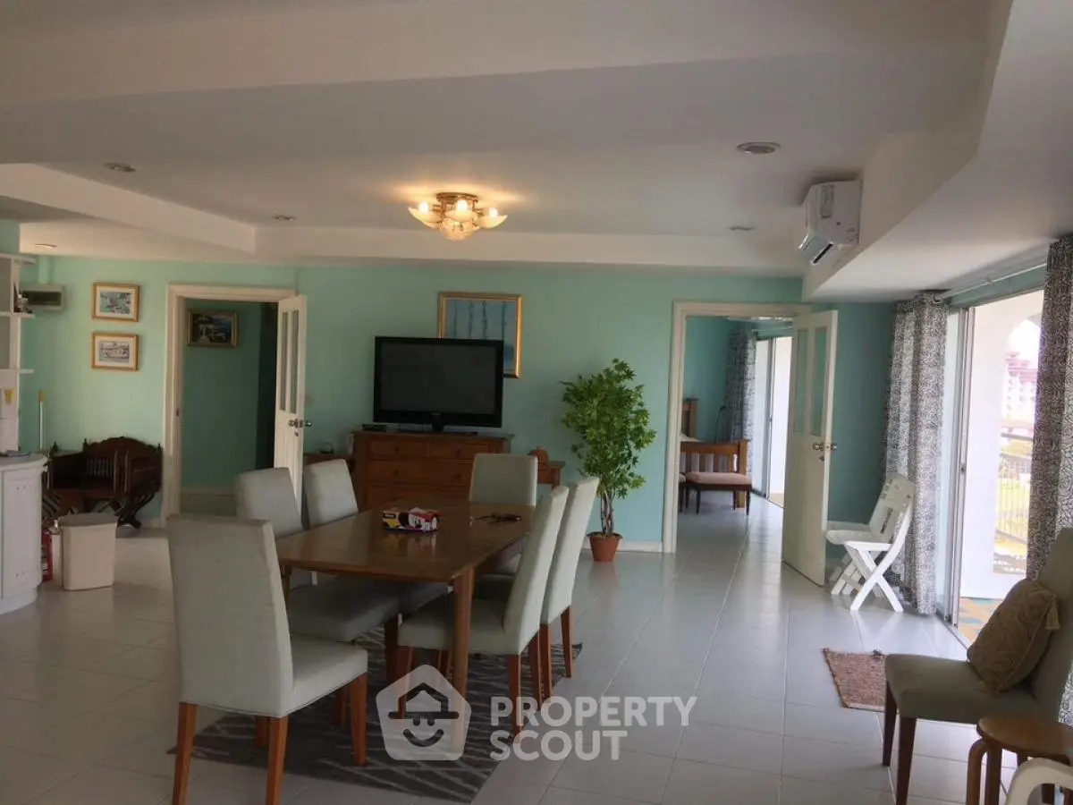 Spacious open-plan living and dining area with modern decor and natural light.