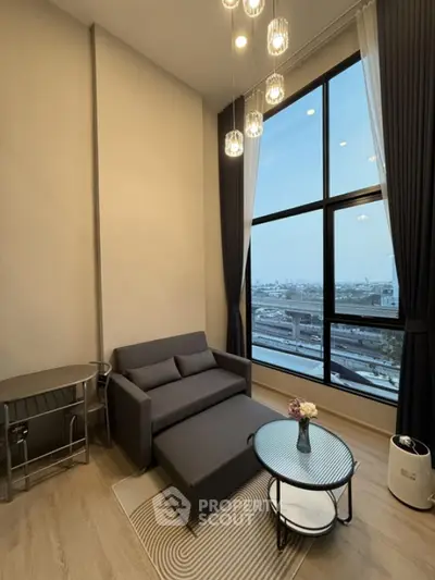 Modern living room with large windows and city view, featuring stylish furniture and elegant lighting.