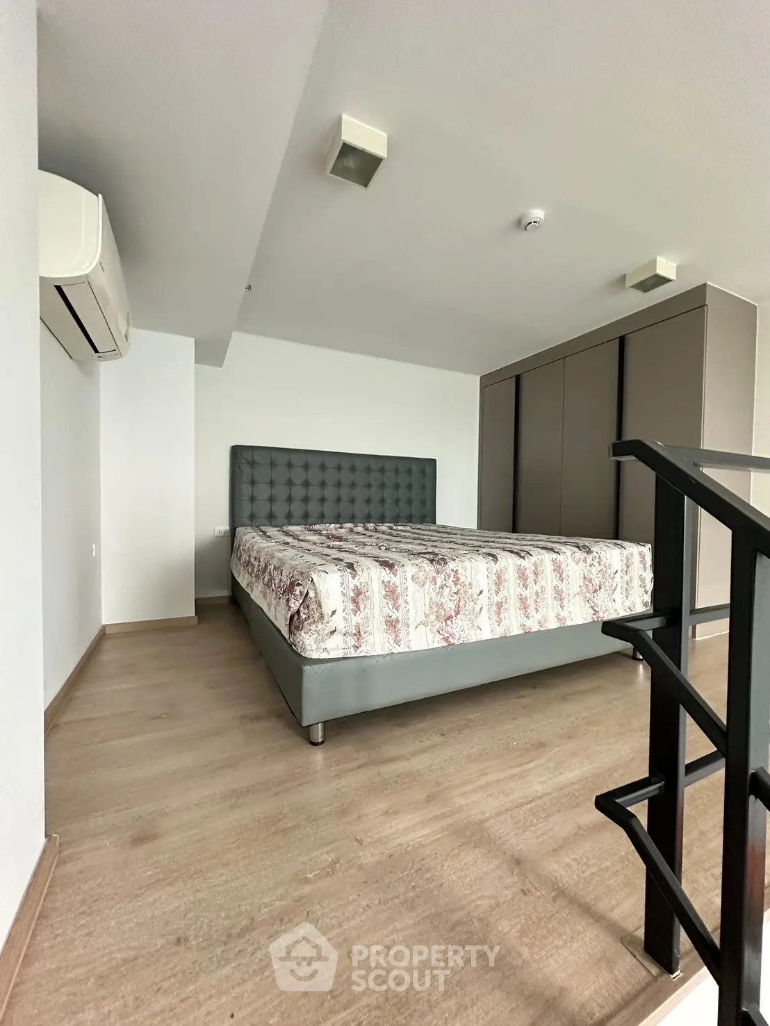 Spacious bedroom with modern decor and ample storage in a stylish apartment.