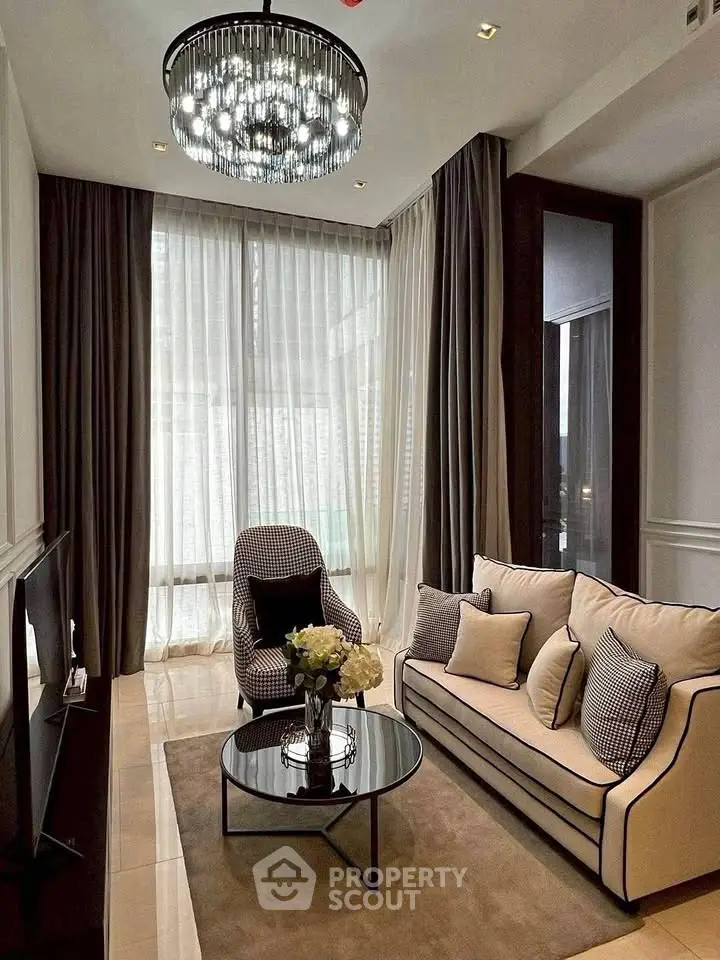 Elegant living room with modern chandelier and floor-to-ceiling windows.