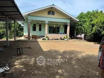 Charming single-story home with spacious yard and lush greenery, perfect for serene living.