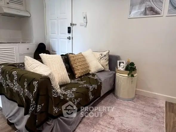 Cozy living room with stylish sofa and decorative cushions in modern apartment.