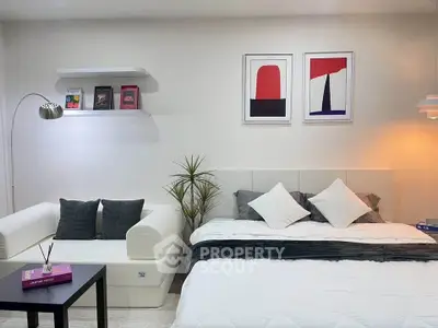 Modern bedroom with stylish decor and cozy seating area