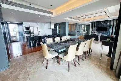 Luxurious open-plan dining and kitchen area with modern furnishings and elegant design.