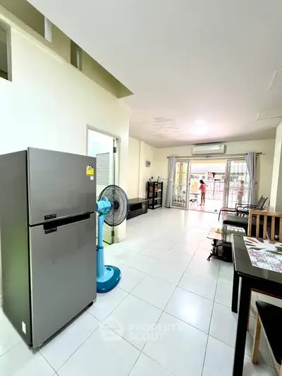 Spacious living area with modern appliances and open layout, perfect for comfortable living.