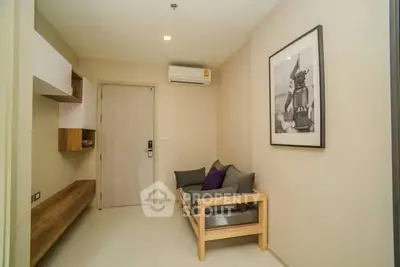 Cozy living room with modern decor and air conditioning in a stylish apartment.