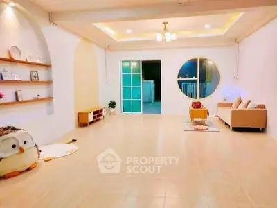 Spacious living room with modern decor and cozy seating area, perfect for relaxation.