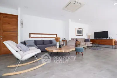 Spacious modern living room with stylish furniture and natural light.