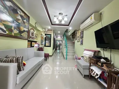 Spacious living room with modern decor and staircase in stylish home