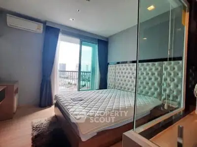 Modern bedroom with city view and glass partition, featuring elegant decor and natural light.