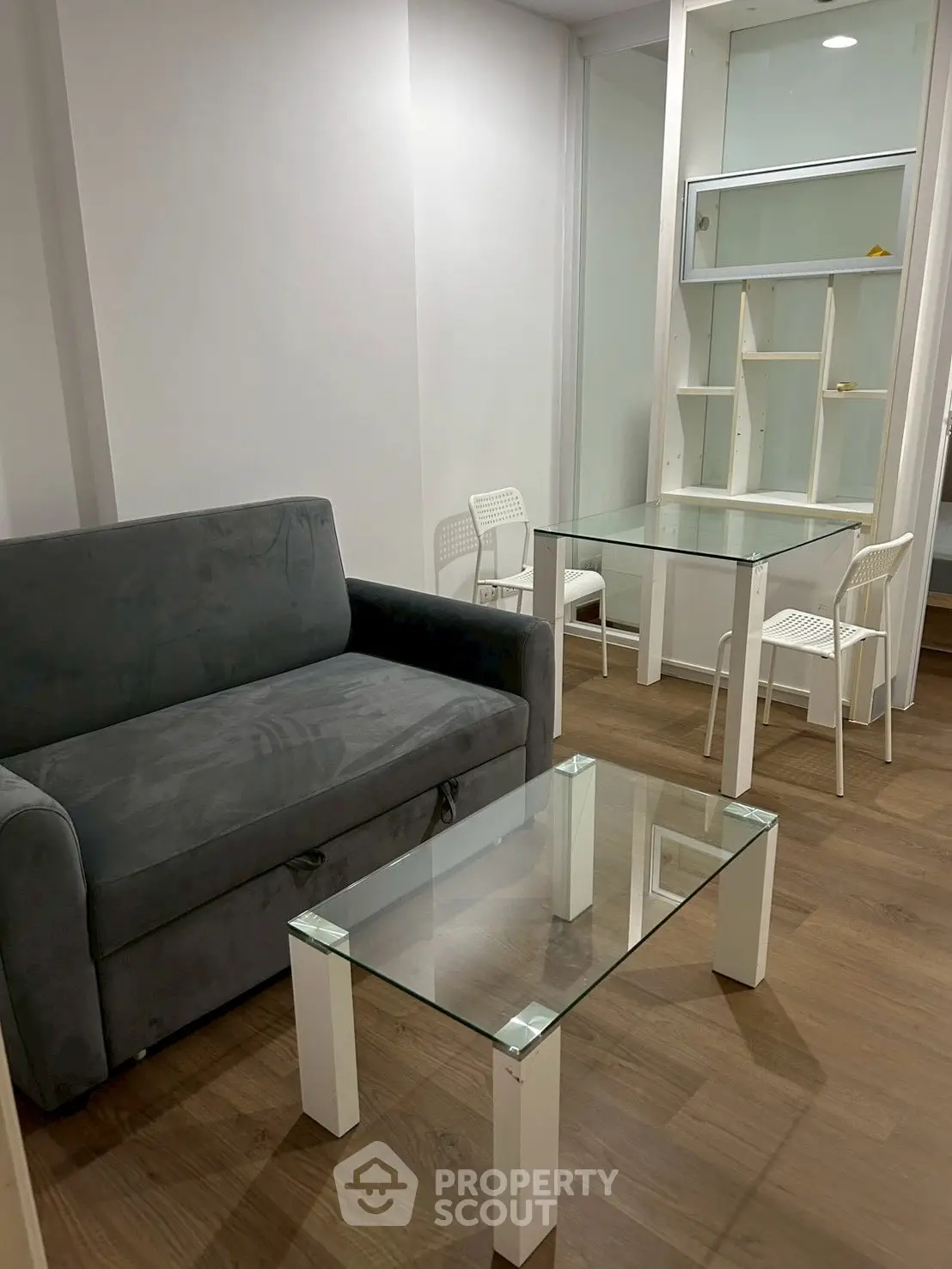 Modern living room with sleek furniture and glass tables, perfect for urban living.