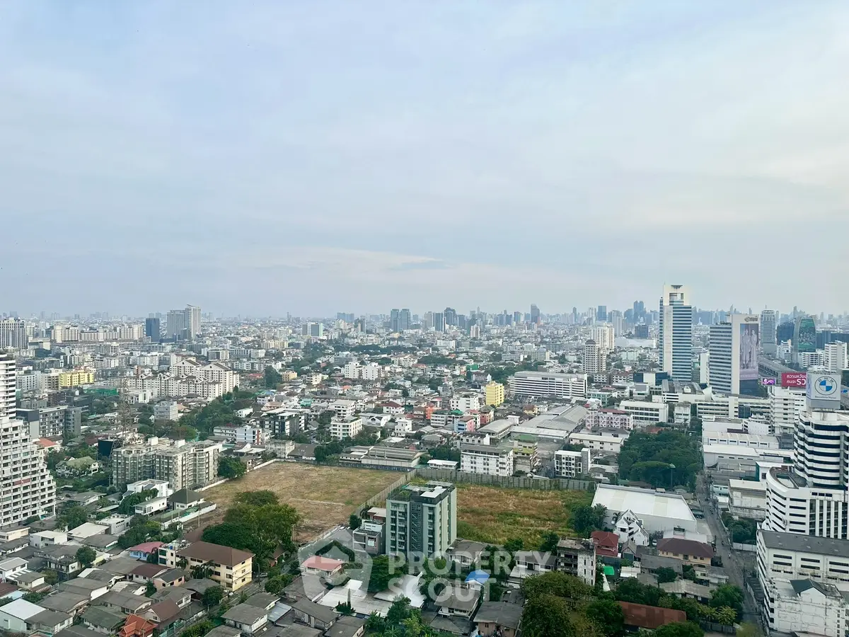 Stunning panoramic cityscape view from high-rise building, showcasing urban skyline and vibrant city life.