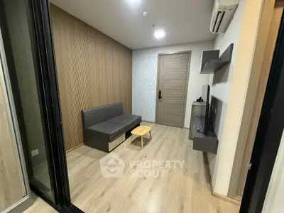 Modern living room with wooden flooring and minimalist furniture