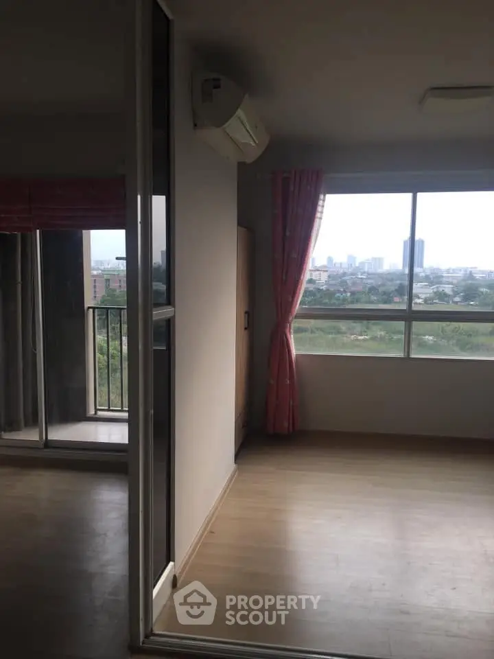 Spacious apartment with large windows offering stunning city views and natural light.