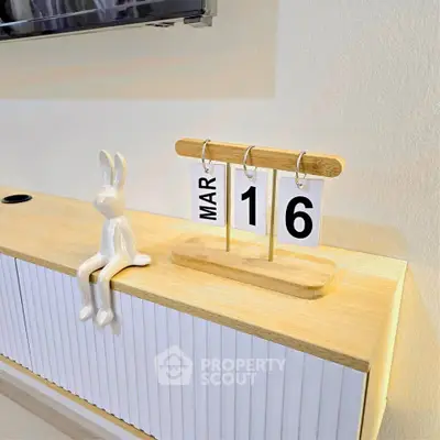 Stylish modern interior with decorative elements on a wooden console table.