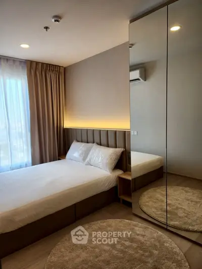 Modern bedroom with mirrored wardrobe and cozy lighting