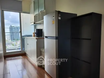 Modern kitchen with sleek appliances and city view from balcony