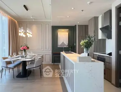 Elegant open-plan kitchen and dining area with modern decor and stylish lighting