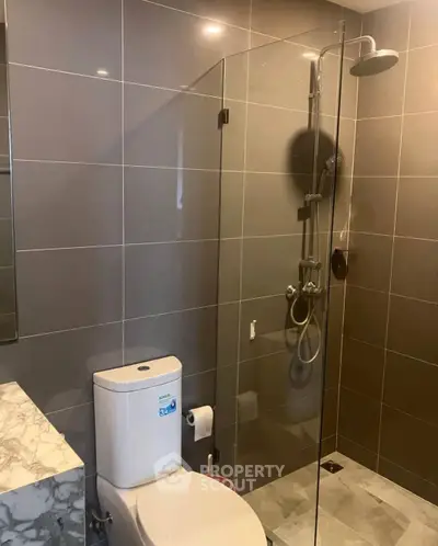 Modern bathroom with glass shower and sleek tile design